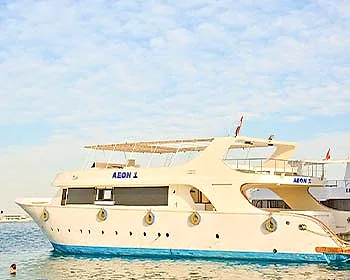 Aeon 1 alongside, seen from the bow quarter, her name on the hull.